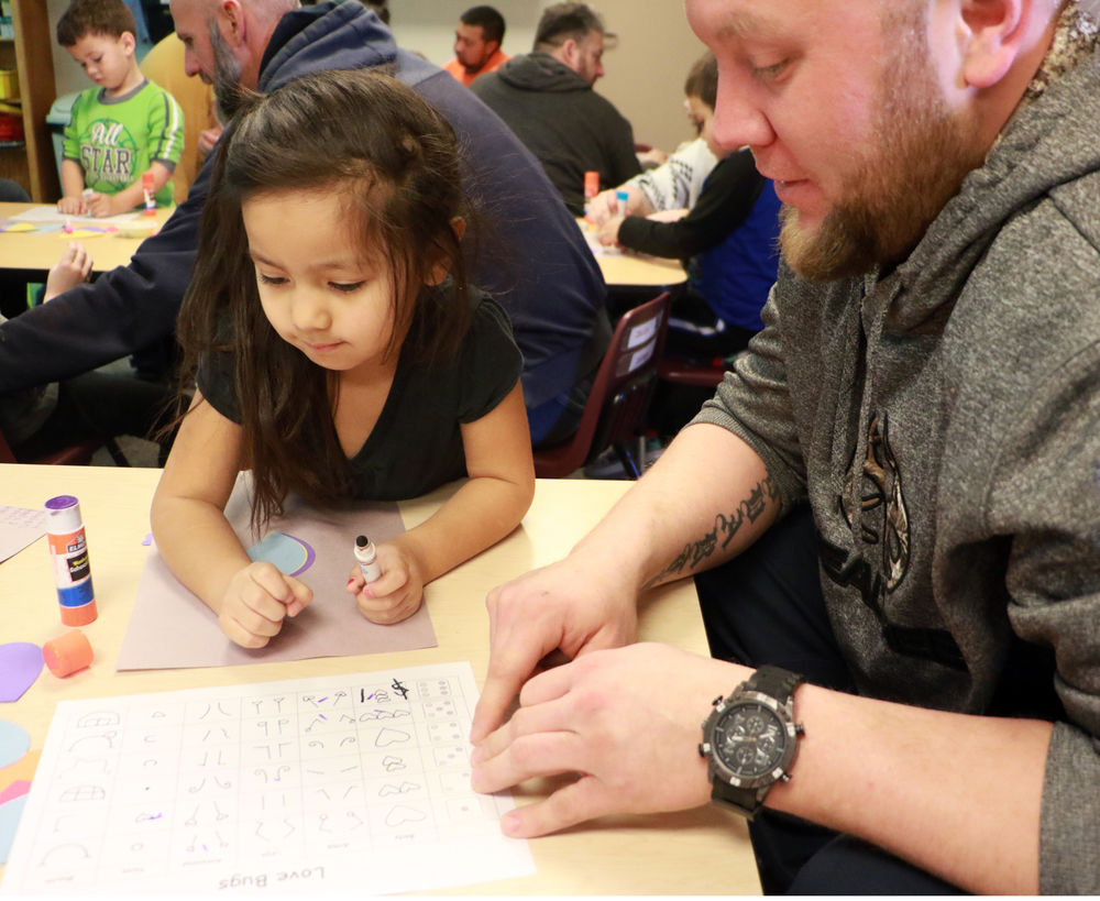 Bearcub Preschool students make Love Bugs with dad